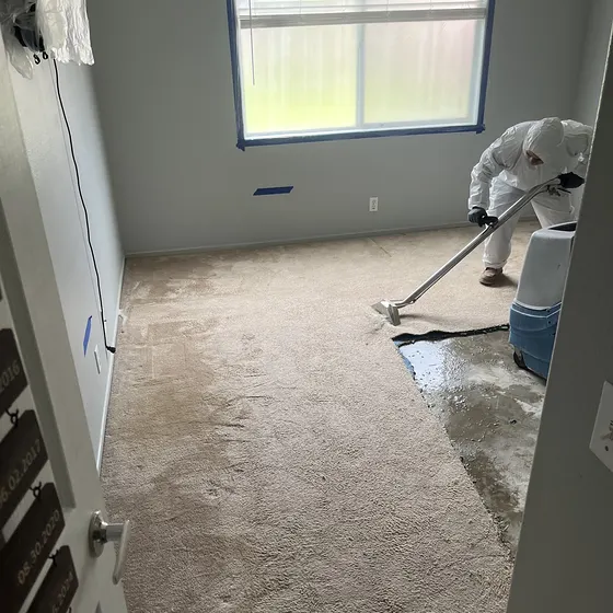 Extracting water from wet carpet, San Bernardino Valley