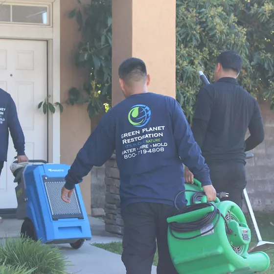 Crew bringing drying equipment to a home, San Bernardino Valley