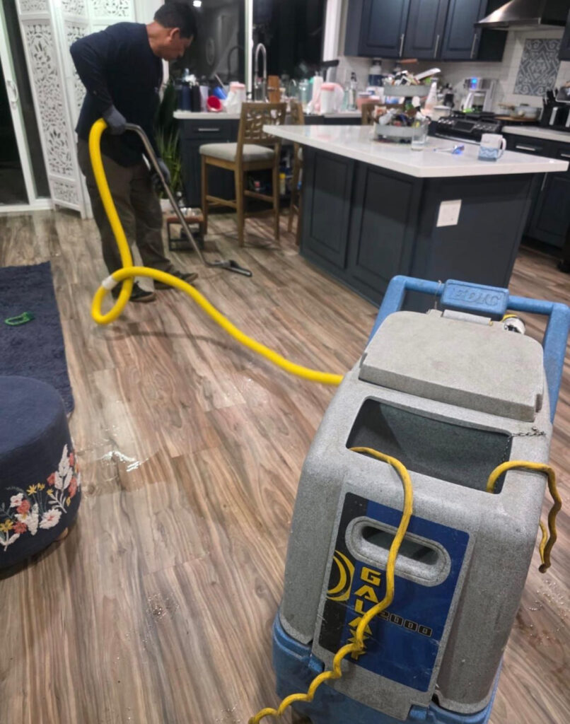 Green Planet Restoration technician using professional water extraction equipment in Long Beach, CA 90808.