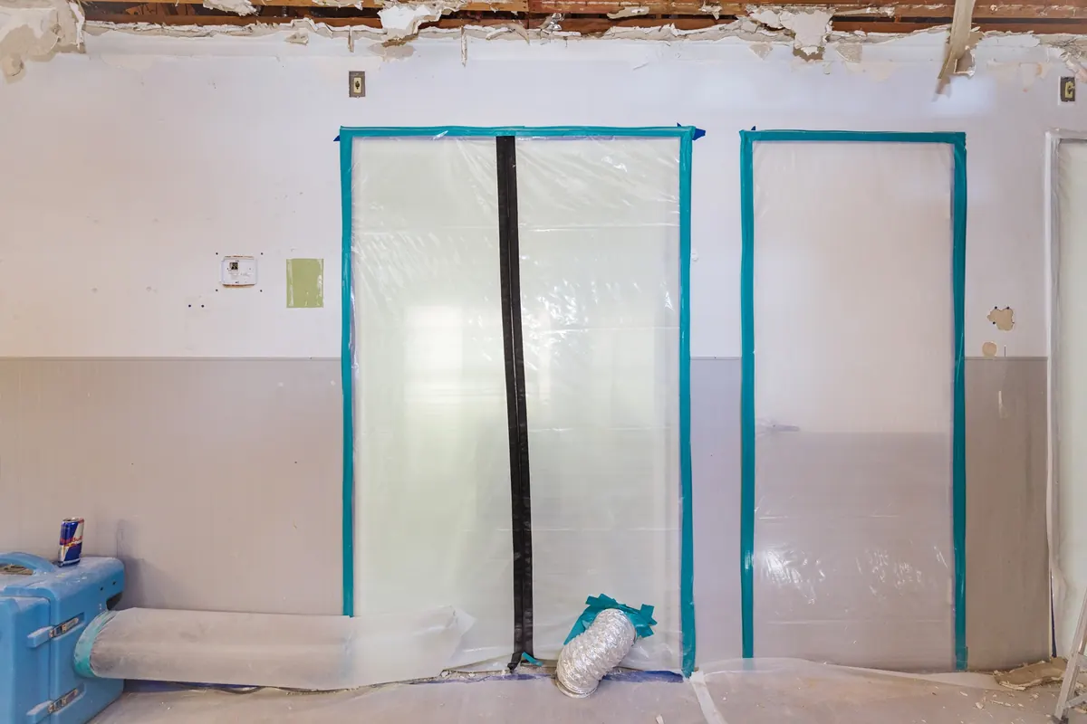 Plastic containment with zip doors for mold remediation