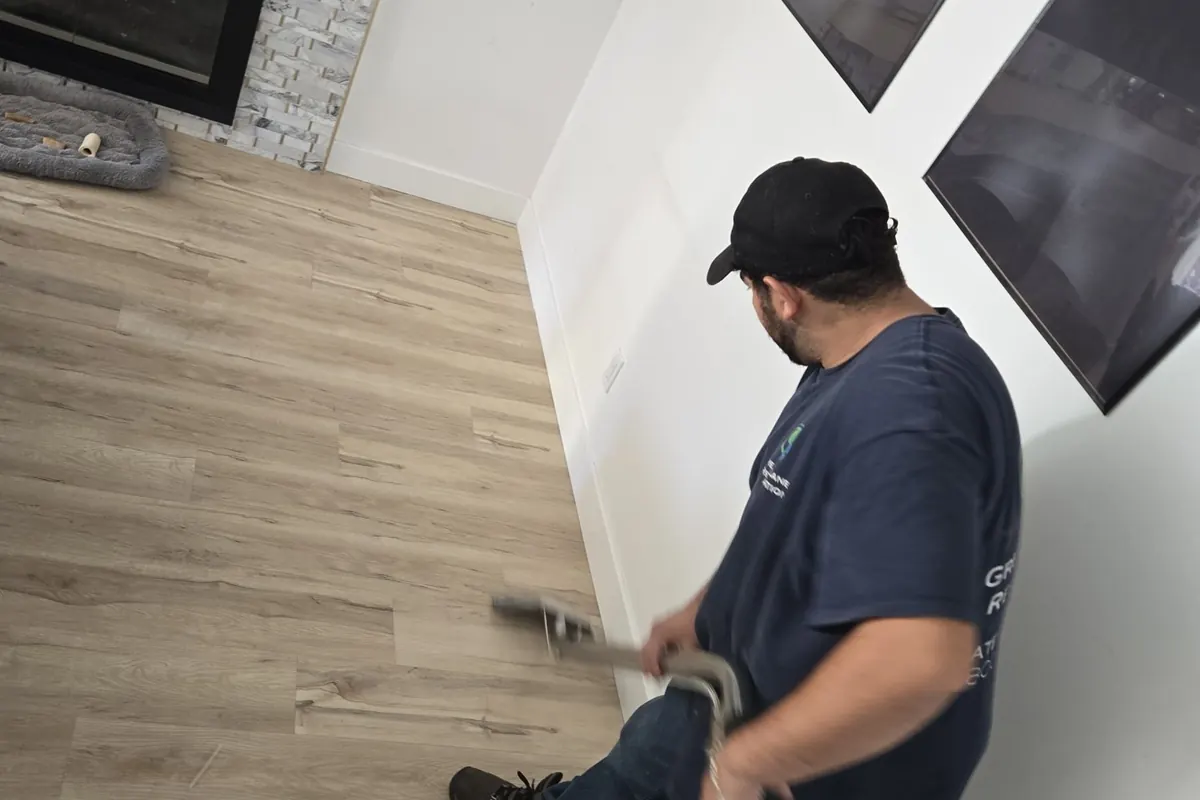 Technician extracting water from flooring