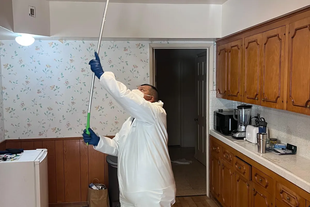 Technician cleaning smoke film from upper walls