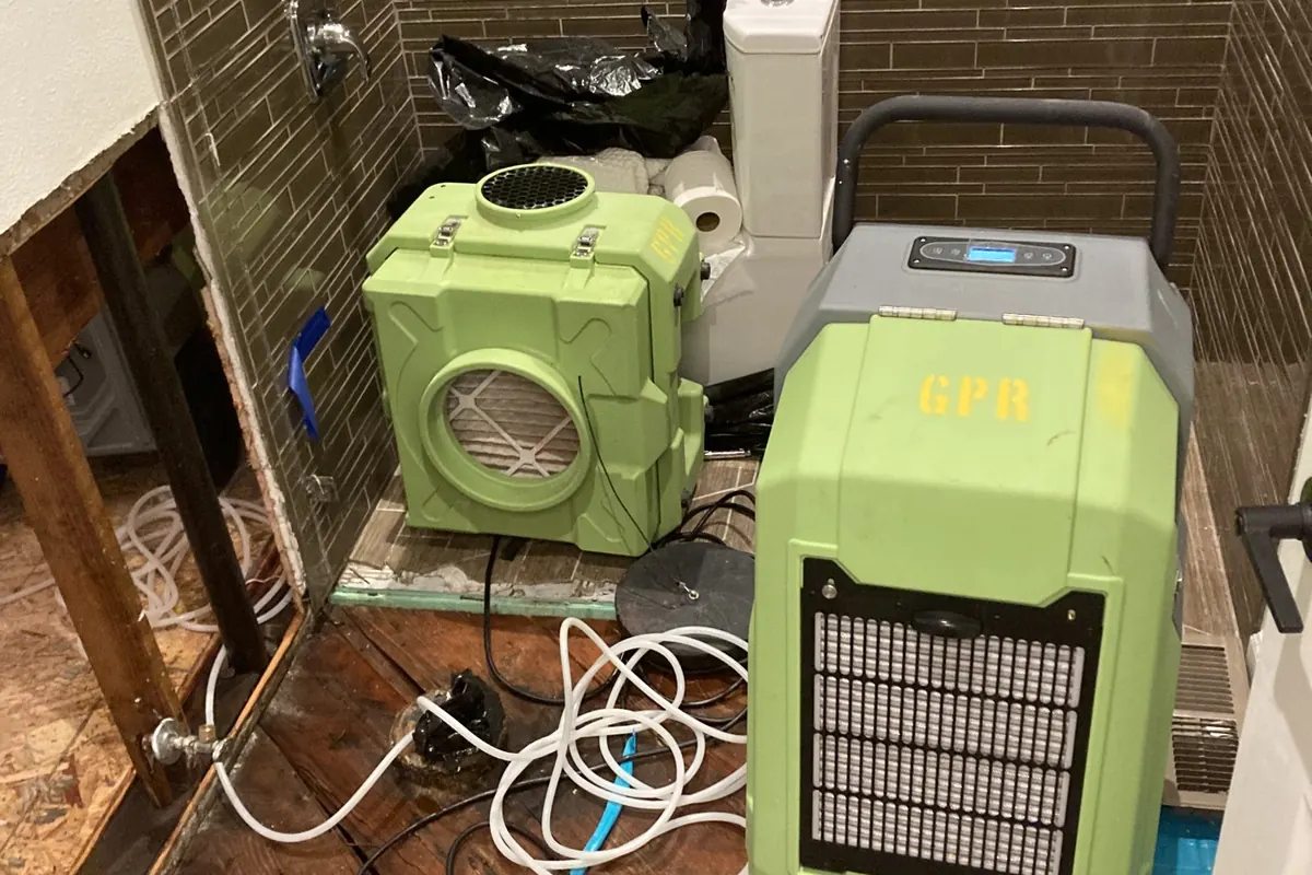 HEPA air scrubber running inside containment