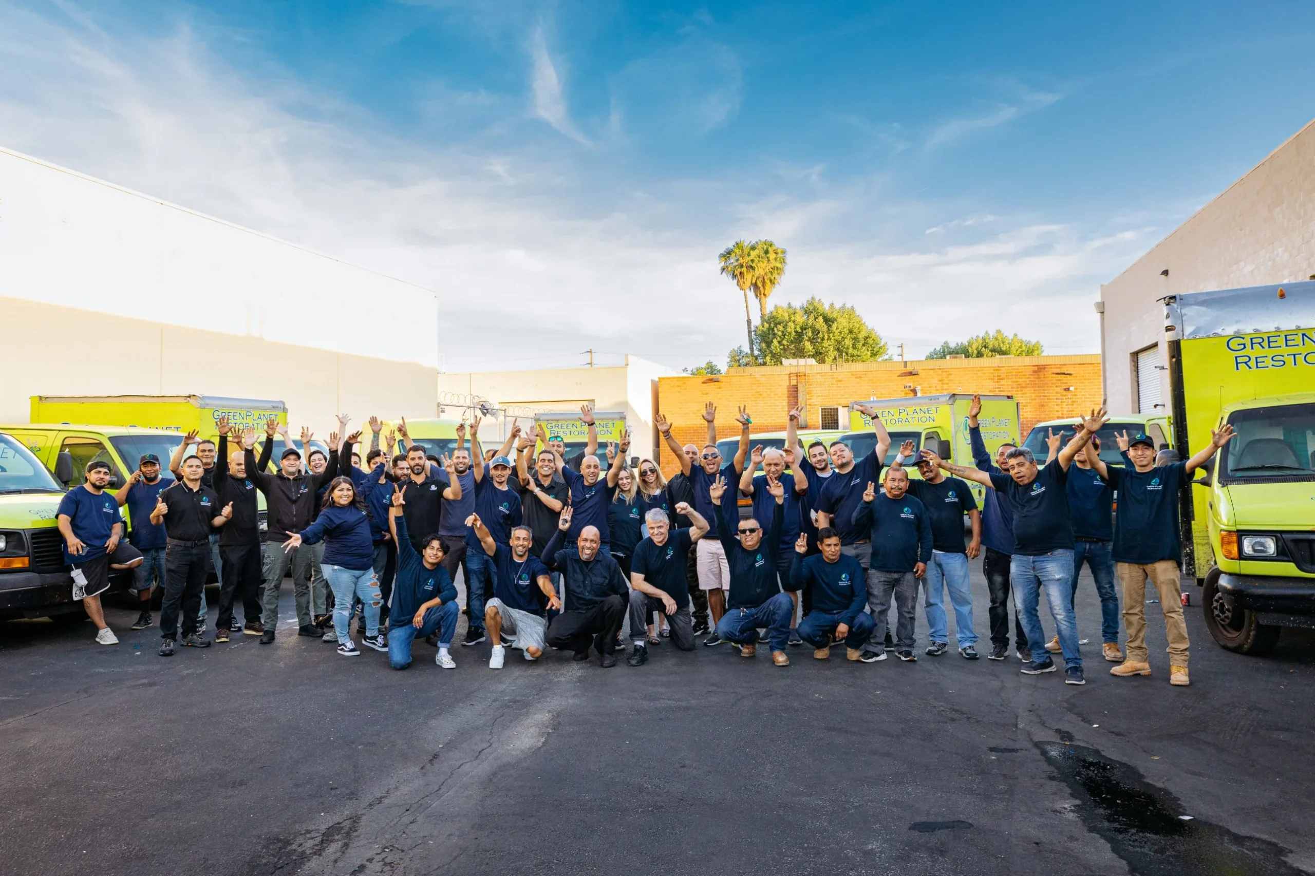 The Green Planet Restoration team in front of the company's response trucks
