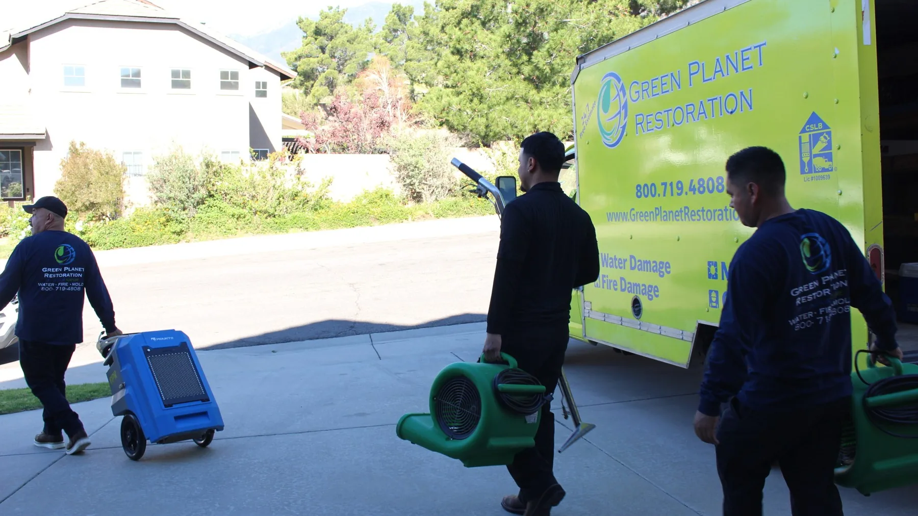 Green Planet technician inspecting a home exterior