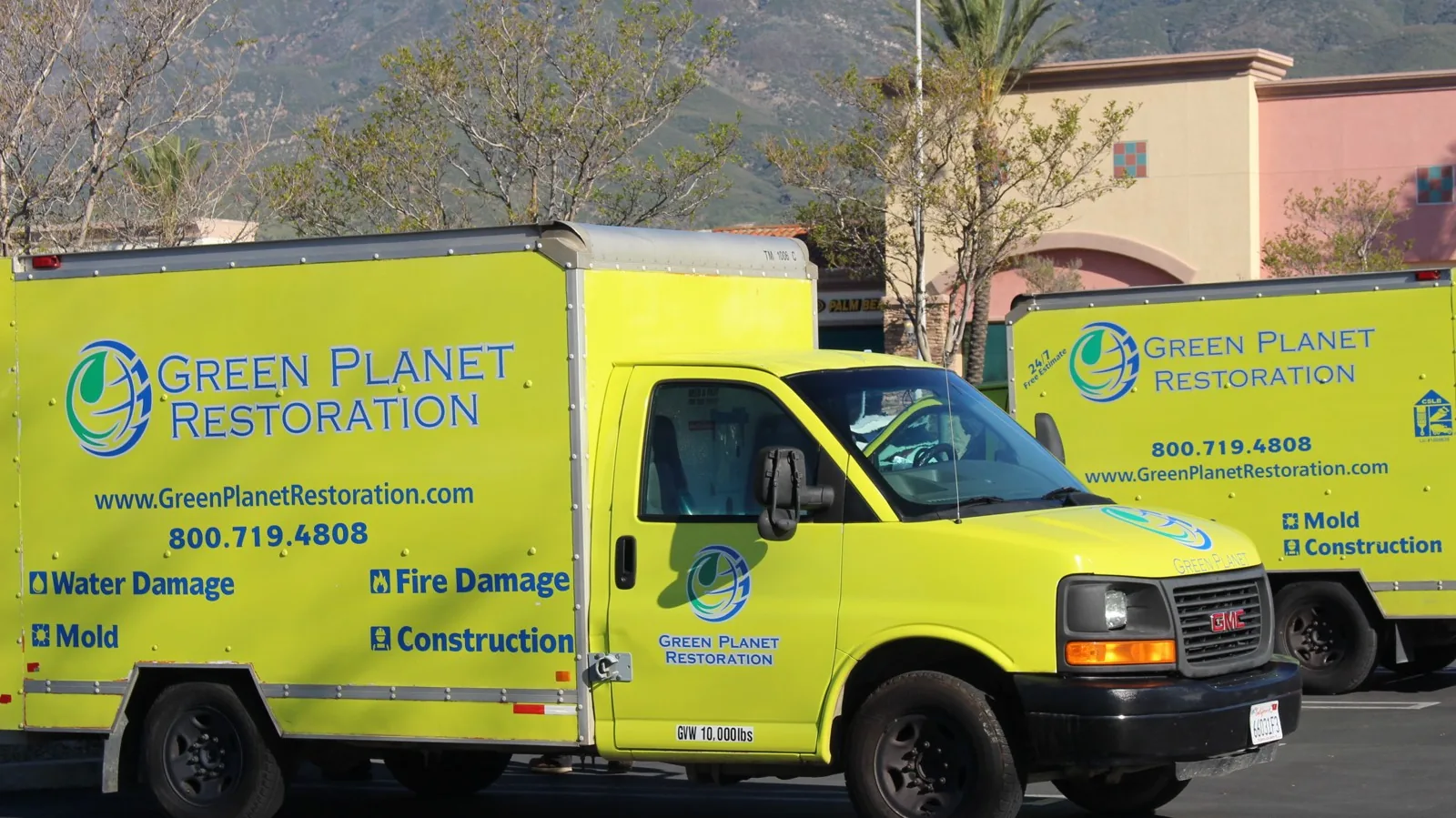 Green Planet Restoration service trucks parked in a lot