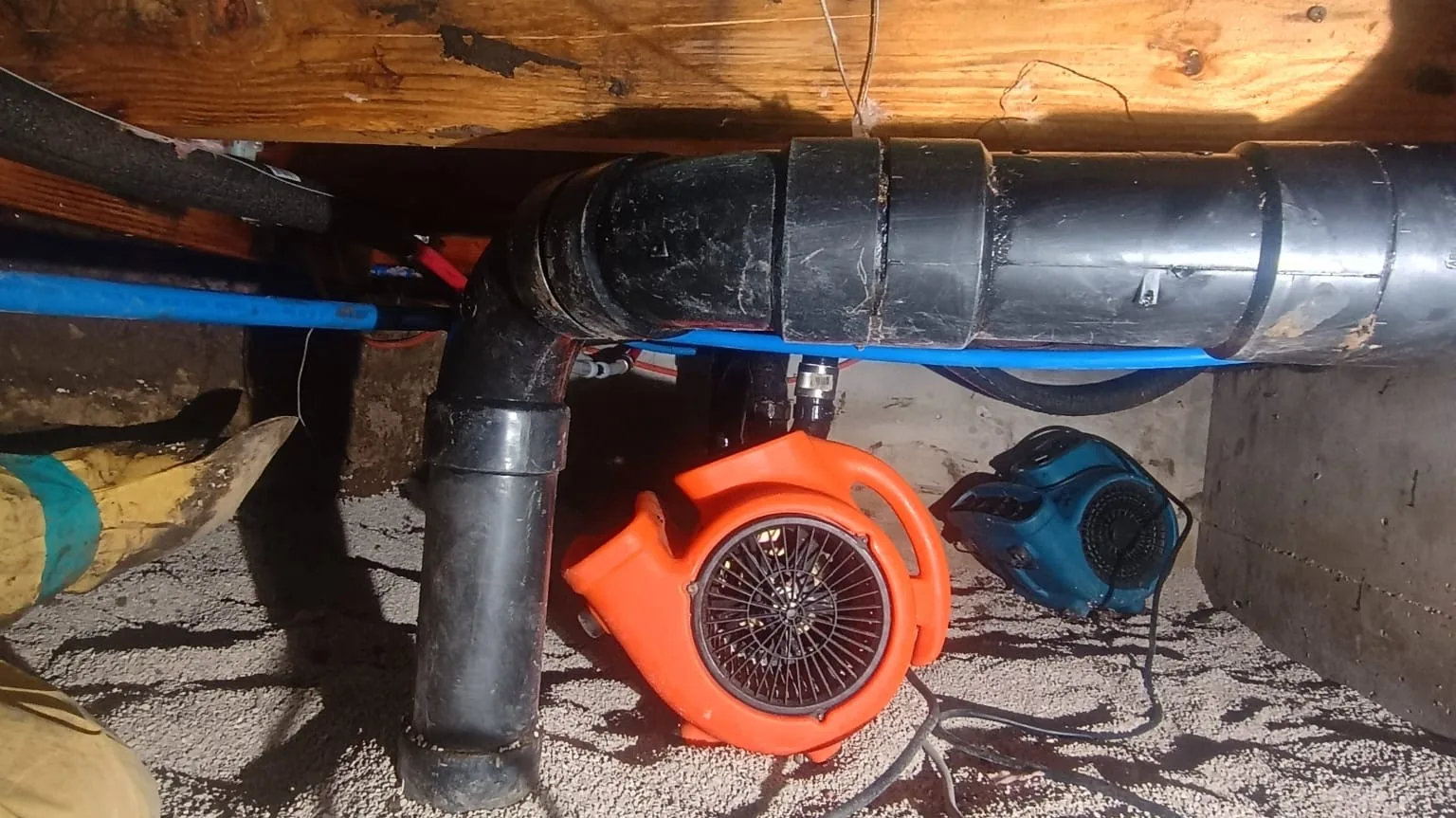 Air mover drying a crawl space under a house