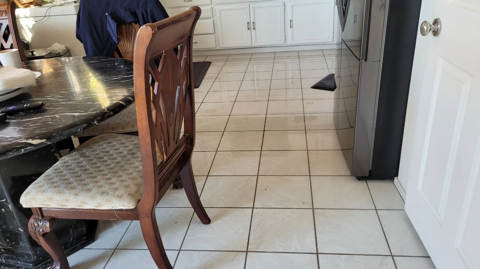 Water spreading across a kitchen tile floor