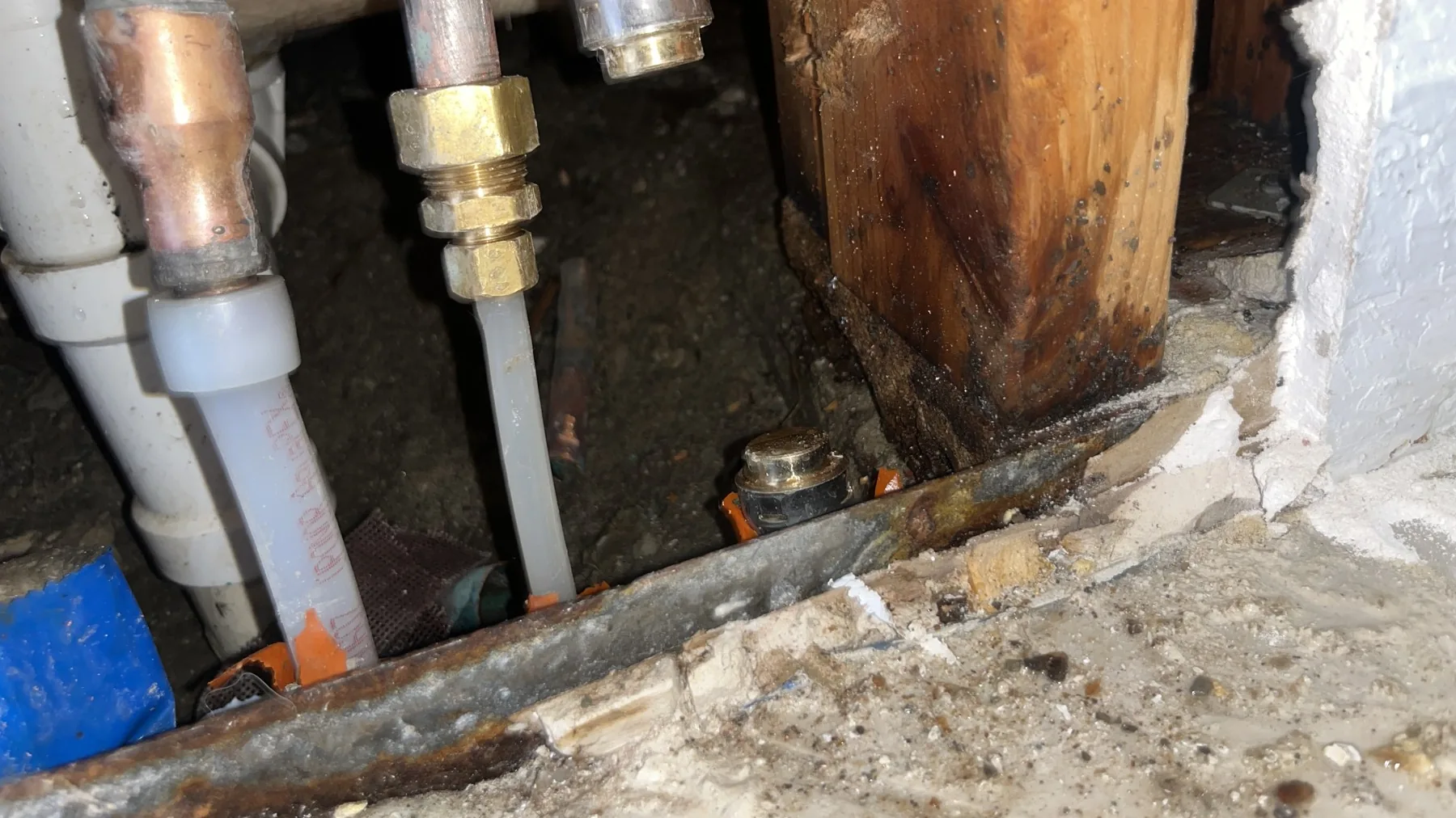 Leaking pipes and wet framing inside an opened wall