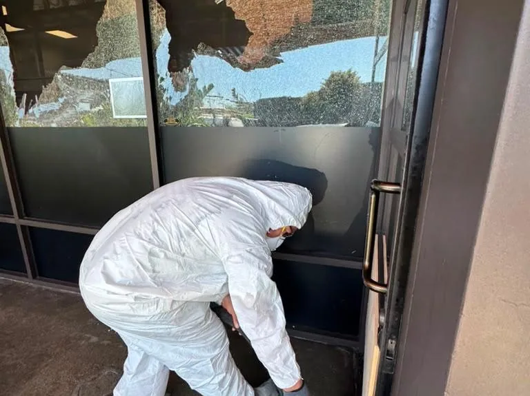 Crew repairing vandalism damage at a property